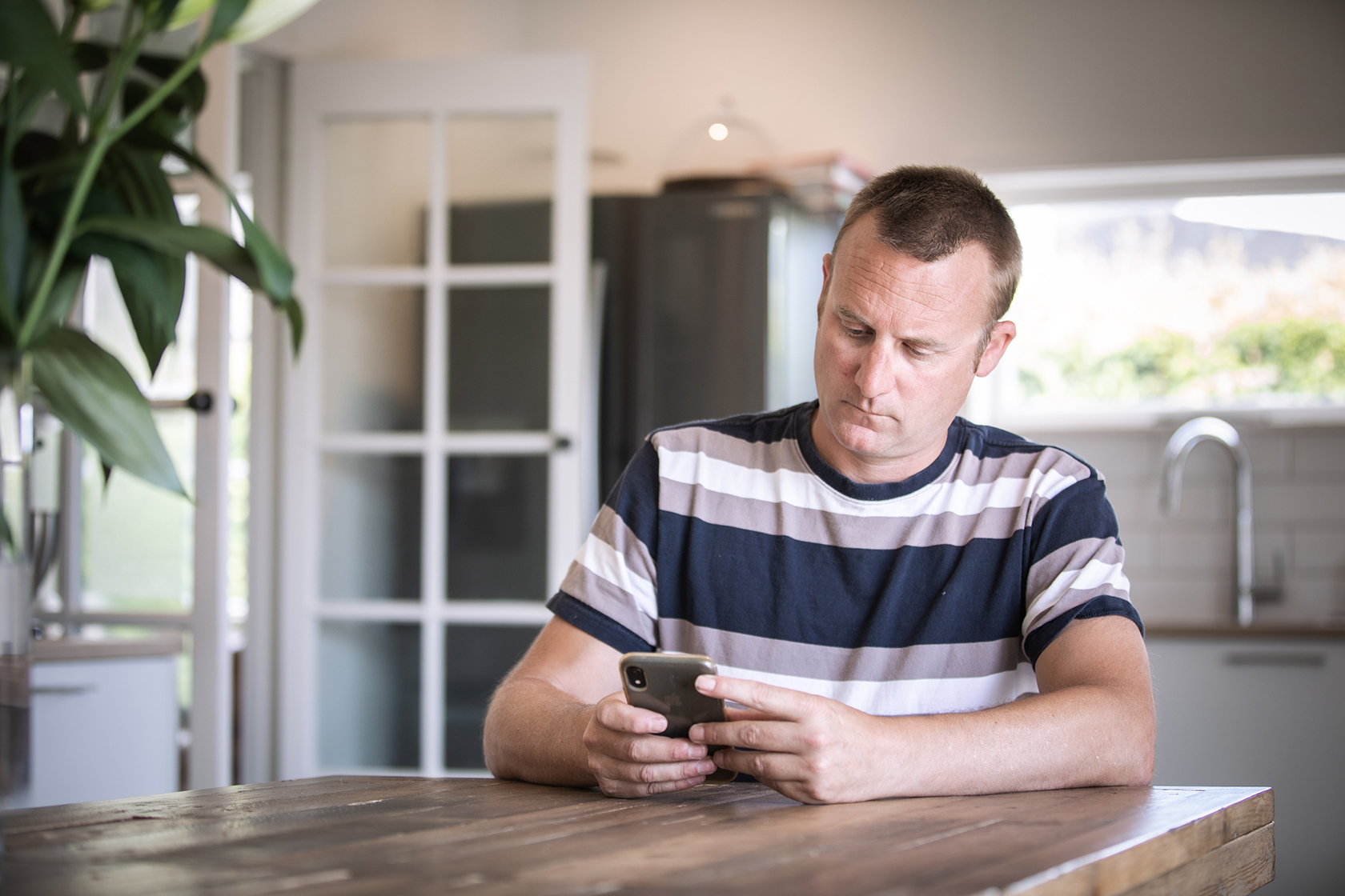 Homeowner at table with phone